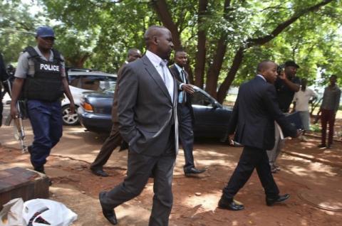 Zimbabwe's Prosecutor General Johannes Tomana (C) arrives escorted by policemen at the Harare Magistrates court, February 2, 2016. PHOTO BY REUTERS/Philimon Bulawayo