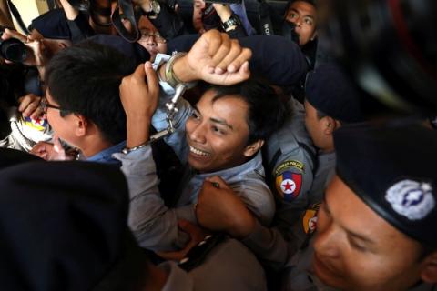 Reuters journalists Kyaw Soe Oo (C) and Wa Lone (L) appear in court in Yangon, Myanmar, January 10, 2018. PHOTO BY REUTERS/Stringer