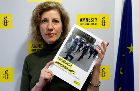 Julia Hall, Amnesty International's expert on counter terrorism, poses with a report on the effect of counter terrorism measures on human rights across Europe, in Brussels, Belgium, January 17, 2017. PHOTO BY REUTERS/Francois Lenoir