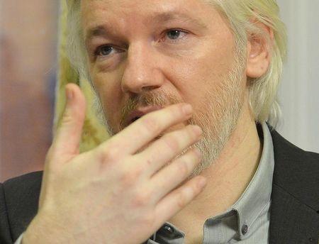 WikiLeaks founder Julian Assange gestures during a news conference at the Ecuadorian embassy in central London, August 18, 2014. PHOTO BY REUTERS/John Stillwell