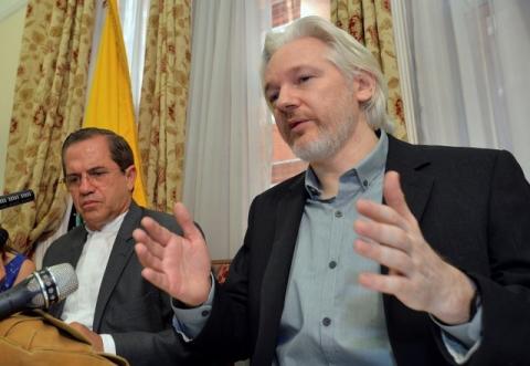 WikiLeaks founder Julian Assange (R) speaks as Ecuador's Foreign Affairs Minister Ricardo Patino listens, during a news conference at the Ecuadorian embassy in central London, August 18, 2014. PHOTO BY REUTERS/John Stillwell
