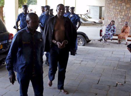 Policemen escort detained Burundi Army general Juvenal Niyungeko to a high court in Bujumbura, Burundi, May 16, 2015. PHOTO BY REUTERS/Goran Tomasevic