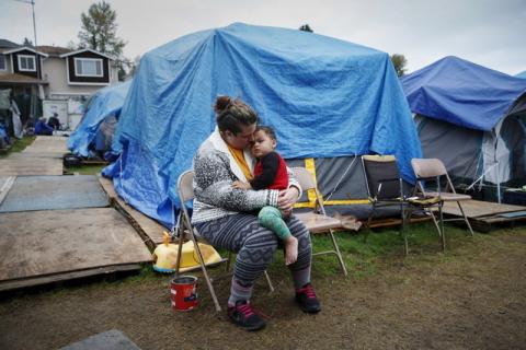 Kadee Ingram, 28, holds her son Sean, 2, at SHARE/WHEEL Tent City 3 outside Seattle, Washington, October 13, 2015. PHOTO BY REUTERS/Shannon Stapleton
