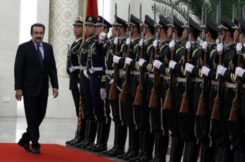 Kazakhstan's Prime Minister Karim Masimov (L) inspects an honour guard during an official welcoming ceremony in the Great Hall of the People in Beijing, March 31, 2012. PHOTO BY REUTERS/David Gray