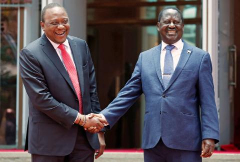 Kenya's President Uhuru Kenyatta (L) greets opposition leader Raila Odinga of the National Super Alliance (NASA) coalition after addressing a news conference at the Harambee house office in Nairobi, Kenya March 9, 2018. PHOTO BY REUTERS/Thomas Mukoya
