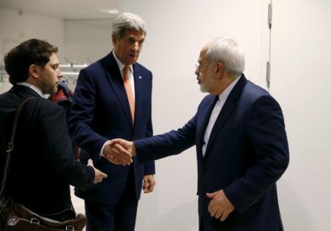 U.S. Secretary of State John Kerry shakes hands with Iranian Foreign Minister Mohammad Javad Zarif after the International Atomic Energy Agency (IAEA) verified that Iran has met all conditions under the nuclear deal, in Vienna, January 16, 2016. PHOTO BY REUTERS/Kevin Lamarque