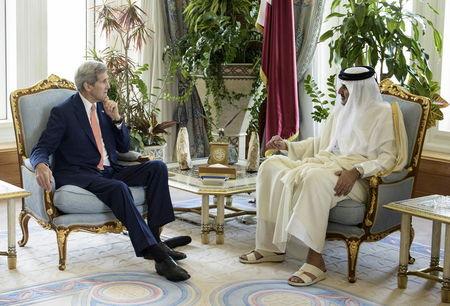 Qatar's Emir Sheikh Tamim bin Hamad al-Thani (R) talks with U.S. Secretary of State John Kerry before their meeting at the Diwan Palace in Doha, August 3, 2015. PHOTO BY REUTERS/Brendan Smialowski