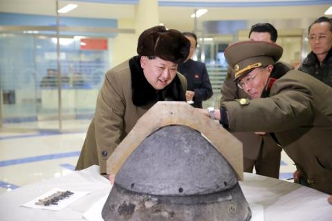 North Korean leader Kim Jong Un looks at a rocket warhead tip after a simulated test of atmospheric re-entry of a ballistic missile, at an unidentified location in this undated file photo released by North Korea's Korean Central News Agency (KCNA) in Pyongyang, March 15, 2016. PHOTO BY REUTERS/KCNA