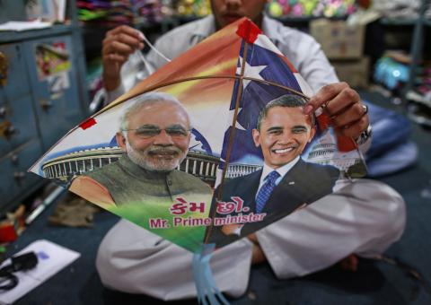 An employee ties threads on a kite, with portraits of Indian Prime Minister Narendra Modi (L) and U.S. President Barack Obama, ahead of Obama's visit, in Mumbai, January 23, 2015. PHOTO BY REUTERS/Danish Siddiqui