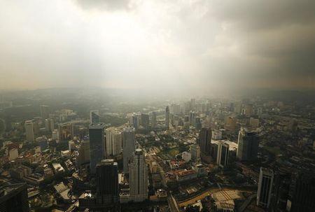 A rain storm clears over central Kuala Lumpur, August 16, 2014. PHOTO BY REUTERS/Olivia Harris