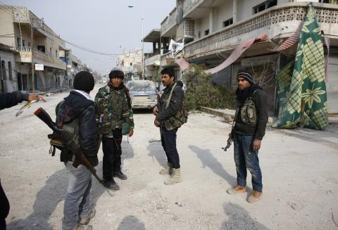 Fighters of the Kurdish People's Protection Units (YPG) patrol in the streets of the northern Syrian town of Kobani, January 28, 2015. PHOTO BY REUTERS/Osman Orsal