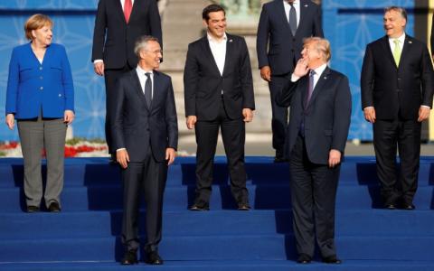 U.S. President Donald Trump, Greek Prime Minister Alexis Tsipras, Hungarian Prime Minister Viktor Orban, German Chancellor Angela Merkel and NATO Secretary General Jens Stoltenberg react as they pose for a family photo at the Park of the Cinquantenaire during the NATO Summit in Brussels, Belgium, July 11, 2018. PHOTO BY REUTERS/Kevin Lamarque