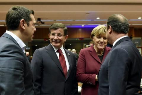 (L to R) Greece's Prime Minister Alexis Tsipras, Turkish Prime Minister Ahmet Davutoglu and German Chancellor Angela Merkel talk to French President Francois Hollande during an EU-Turkey summit in Brussels, Belgium, November 29, 2015. PHOTO BY REUTERS/Eric Vidal