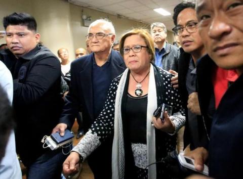 Philippine Senator Leila de Lima is escorted by the Senate's security personnel after a Regional Trial Court (RTC) ordered her arrest, at the Senate headquarters in Pasay city, metro Manila, Philippines, February 23, 2017. PHOTO BY REUTERS/Romeo Ranoco
