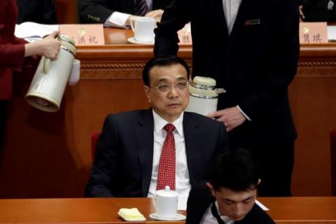 China's Premier Li Keqiang attends the Chinese People's Political Consultative Conference (CPPCC) as attendants serve tea at the Great Hall of the People in Beijing, China, March 3, China, 2017. PHOTO BY REUTERS/Jason Lee