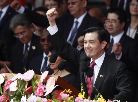 Taiwan's President Ma Ying-jeou raises his fist after giving a speech during National Day celebrations in front of the presidential office in Taipei