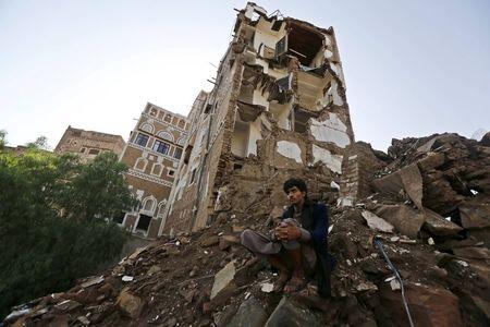 A man sits at a site which the Houthi-led authorities say was hit by a Saudi-led air strike at the old quarter of Yemen's capital Sanaa, August 9, 2015. PHOTO BY REUTERS/Khaled Abdullah