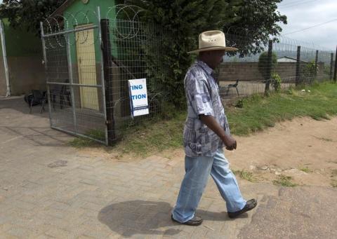 A man leaves a voting station after registering on the voters roll in Shongweni, 40 kilometres west of Durban