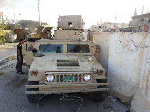 A man looks at a vehicle belonging to the Iraqi security forces in the Anbar province town of Hit, October 6, 2014. PHOTO BY REUTERS/Stringer