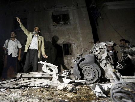 A man reacts as he stands next to wreckage at the site of a car bomb attack outside his house in Sanaa, June 29, 2015. PHOTO BY REUTERS/Khaled Abdullah