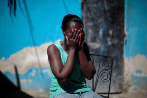 Marieline Jean, who was deported back to Haiti from the United States, covers her face with her hands as she poses for a portrait at the house where she lives, in Port-au-Prince, Haiti, January 30, 2017. PHOTO BY REUTERS/Andres Martinez Casares