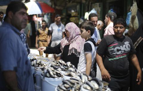 Palestinians shop at a market in Khan Younis in the southern Gaza Strip