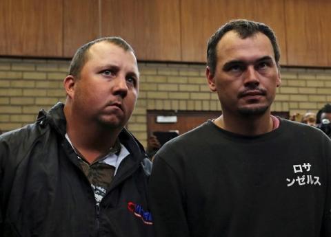 Theo Martins and Willem Oosthuizen (R) appear in court after an online video emerged showing them pushing a black man into a coffin and threatening to burn him alive, at the Middelburg magistrates High Court, in Mpumalanga province, South Africa, November 16, 2016. PHOTO BY REUTERS/Siphiwe Sibeko