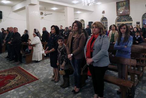 Iraqi Christians pray during a mass on Christmas eve at Sacred Heart Catholic Church in Baghdad, December 24, 2014. PHOTO BY REUTERS/ Thaier Al-Sudani