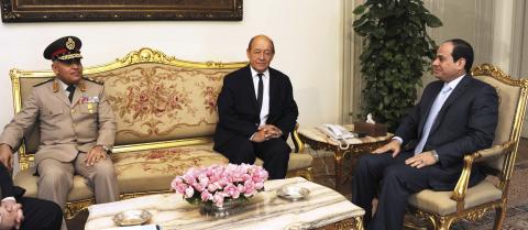 Egyptian President Abdel Fattah al-Sisi (R) meets with French Defence Minister Jean-Yves Le Drian (C) and Egyptian Defence Minister Sedki Sobhi (L) in Cairo