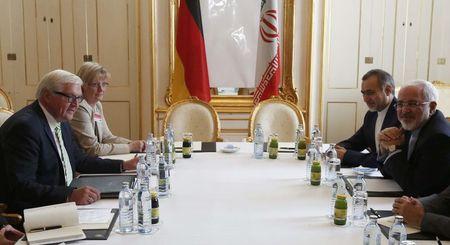 German Foreign Minister Frank-Walter Steinmeier (L) and Iranian Foreign Minister Javad Zarif wait for the start of a bilateral meeting in Palais Coburg, the venue for nuclear talks in Vienna, Austria, July 2, 2015. PHOTO BY REUTERS/Leonhard Foeger
