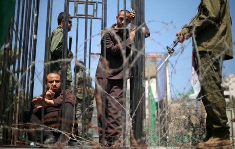 Men play the role of jailed Palestinians and Israeli soldiers during a rally in support of Palestinian prisoners on hunger strike in Israeli jails, in Gaza City, April 17, 2017. PHOTO BY REUTERS/Mohammed Salem