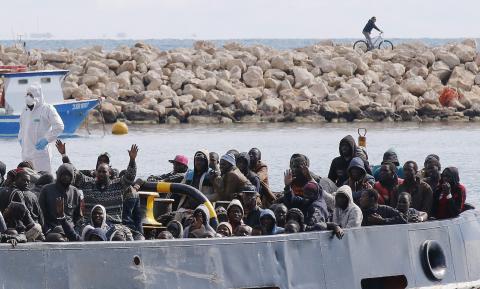 Migrants arrive by boat at the Sicilian harbour of Pozzallo, February 15, 2015. PHOTO BY REUTERS/Antonio Parrinello