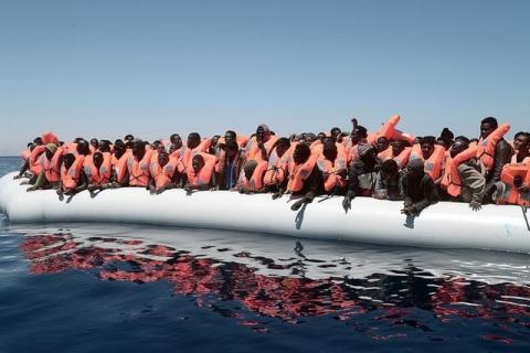 A plastic raft overcrowded with migrants is seen drifting during a search and rescue operation by rescue ship Aquarius, operated by SOS Mediterranean and Doctors without Borders, in central Mediterranean Sea May 18, 2017. Kenny Karpov/SOS Mediteranee/Reuters.
