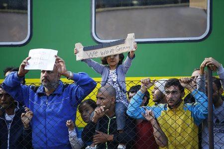 Migrants stage a protest in front of a train at Bicske railway station, Hungary, September 4, 2015. PHOTO BY REUTERS/Leonhard Foeger