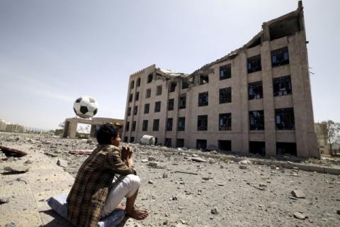 A Houthi militant sits amidst debris from the Yemeni Football Association building, which was damaged in a Saudi-led air strike, in Sanaa, May 31, 2015. PHOTO BY REUTERS/Mohamed al-Sayaghi