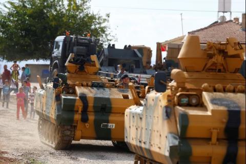 A Turkish military convoy drives by a village on the Turkish-Syrian border line in Reyhanli, Hatay province, Turkey, October 11, 2017. PHOTO BY REUTERS/Osman Orsal