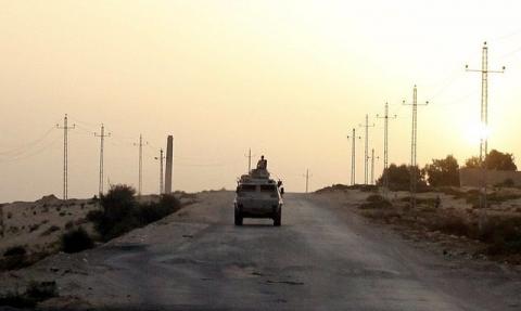 An Egyptian military vehicle is seen on the highway in northern Sinai, Egypt, May 25, 2015. REUTERS/Asmaa Waguih