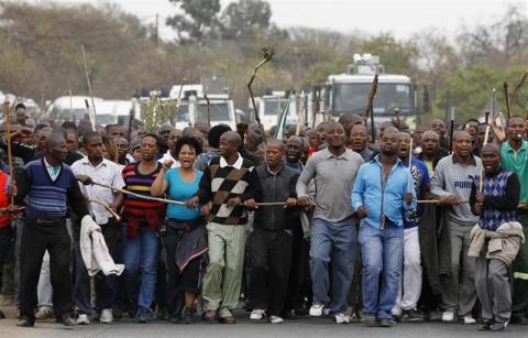Mineworkers take part in a march