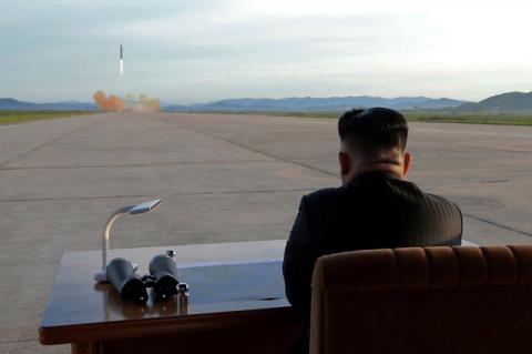 North Korean leader Kim Jong Un watches the launch of a Hwasong-12 missile in this undated photo released by North Korea's Korean Central News Agency (KCNA) on September 16, 2017. PHOTO  BY REUTERS/KCNA