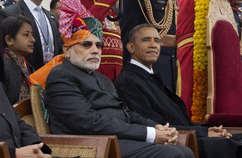 India's Prime Minister Narendra Modi (L) and U.S. President Barack Obama watch India's Republic Day parade in the rain together from their review stand in New Delhi, January 26, 2015. PHOTO BY REUTERS/Stephen Crowley