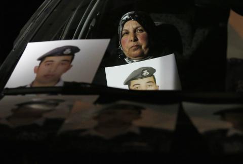 Mother of Islamic State captive Jordanian pilot Muath al-Kasaesbeh holds his picture while sitting in a car, as she takes part in a demonstration demanding that the Jordanian government negotiate with Islamic state and for the release of her son, in front of the prime minister's building in Amman, January 27, 2015. PHOTO BY REUTERS/Muhammad Hamed
