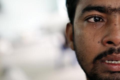Muhammed Ariful Islam, 22, a Dhaka painter who was held captive on a ship before being abandoned on a remote island, cries at a government shelter in Takua Pa district of Phang Nga October 17, 2014. PHOTO BY REUTERS/Athit Perawongmetha