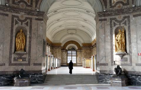 A woman walks in an empty hall at the Royal Museum for Central Africa in Tervuren, near Brussels