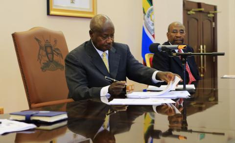 Uganda President Yoweri Museveni signs an anti-homosexual bill into law at the state house in Entebbe, 36 km (22 miles) south west of capital Kampala