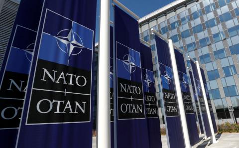 Banners displaying the NATO logo are placed at the entrance of new NATO headquarters during the move to the new building, in Brussels, Belgium, April 19, 2018. PHOTO BY REUTERS/Yves Herman