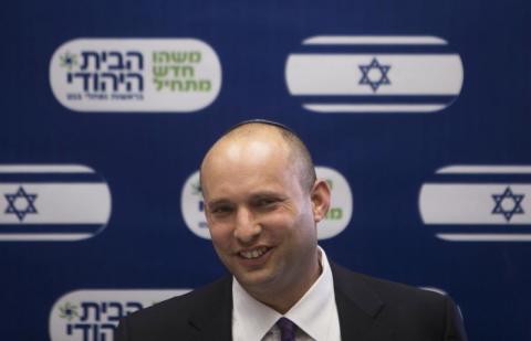 Naftali Bennett, smiles during a Jewish Home party meeting, at the Knesset, the Israeli parliament, in Jerusalem