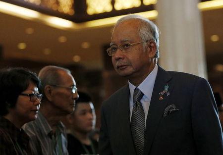 Malaysia's Prime Minister Najib Razak greets family members of victims of Malaysia Airines flight MH17 during a memorial service to mark the first anniversary in Sepang, Malaysia, July 11, 2015. PHOTO BY REUTERS/Olivia Harris