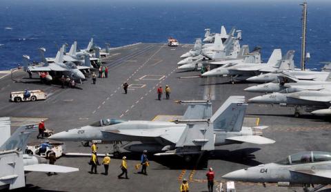A U.S. F18 fighter jet lands on the deck of U.S. aircraft carrier USS Carl Vinson during an annual joint military exercise called "Foal Eagle" between South Korea and U.S., in the East Sea, South Korea, March 14, 2017. PHOTO BY REUTERS/Kim Hong-Ji