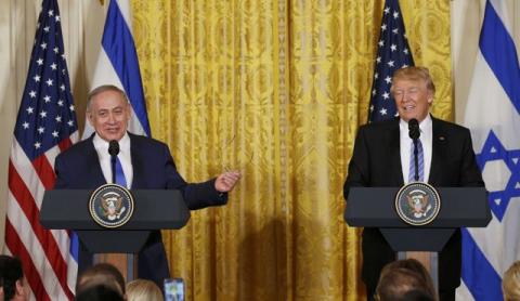 U.S. President Donald Trump (R) laughs with Israeli Prime Minister Benjamin Netanyahu at a joint news conference at the White House in Washington, U.S., February 15, 2017. PHOTO BY REUTERS/Kevin Lamarque