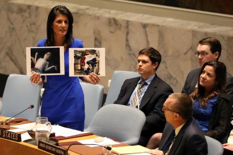 U.S. Ambassador to the United Nations Nikki Haley holds photographs of victims during a meeting at the United Nations Security Council on Syria at the United Nations Headquarters in New York. PHOTO BY  REUTERS/Shannon Stapleton